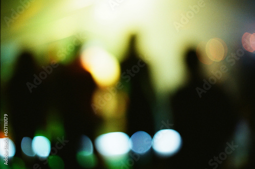 abstract analogue photography: Blurred Silhouettes of Dancing Crowd, energetic concert vibes