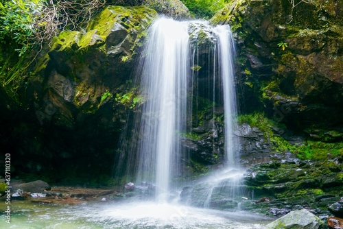 Large rock in front of a beautiful cascading Grotto waterfall