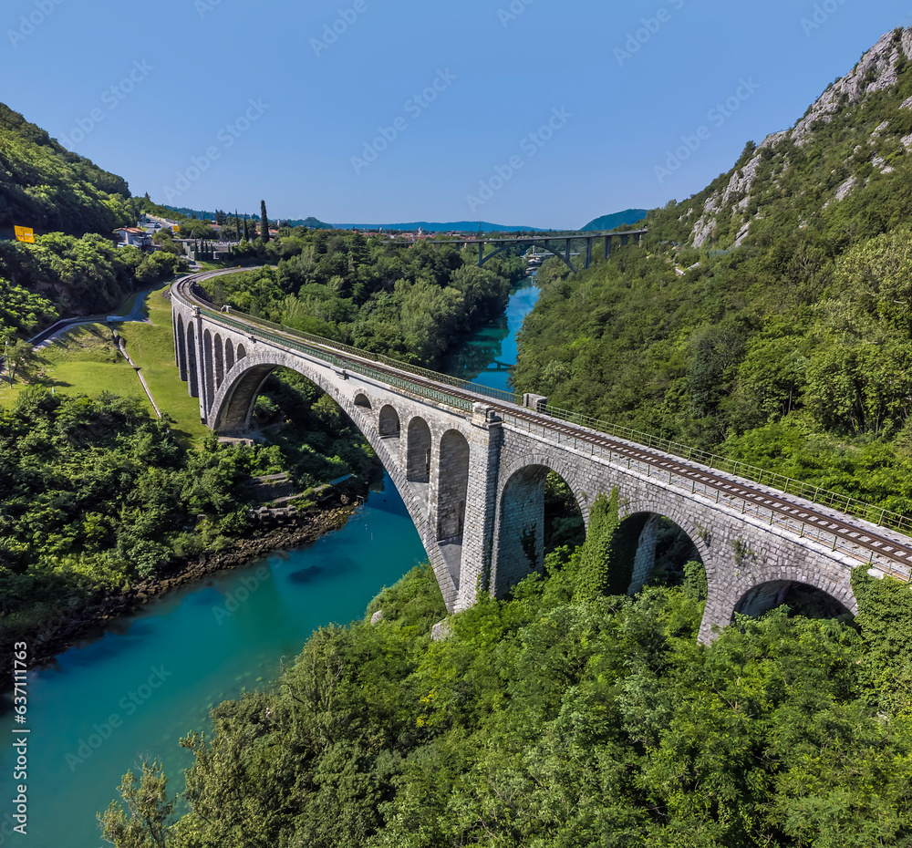 An aerial view above the stone railway bridge on the outskirts of the town of Solkan in Slovenia in summertime