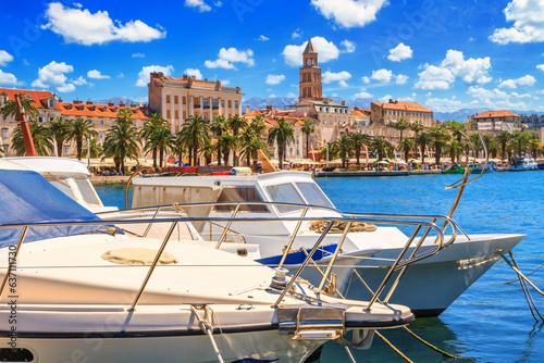 Coastal summer cityscape - view of the embankment the Old Town of Split through moored boats to the pier, the Adriatic coast of Croatia photo