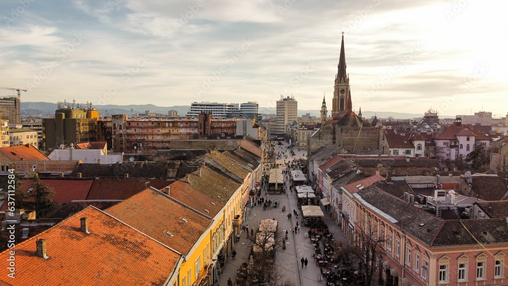 Obraz premium an aerial view of old town, with the tall tower of a church and steep