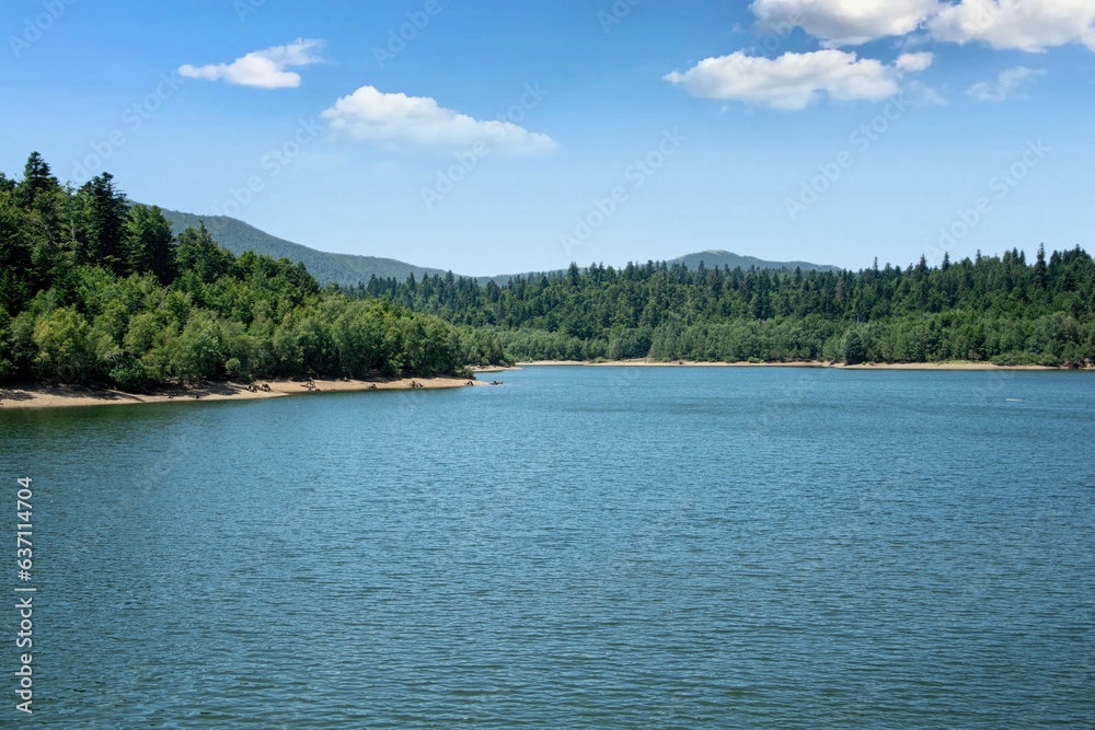 Scenic view of a tranquil lake surrounded by greenery in Fuzina, Croatia Scenic view of a tranquil lake surrounded by greenery in Fuzina, Croatia