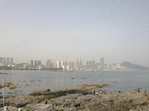 Scenic view of a large city situated on a rocky shoreline