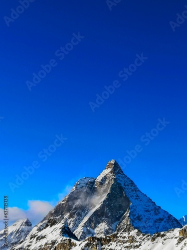 Photography Breathtaking view of the snow-capped mountains against a clear blue sky