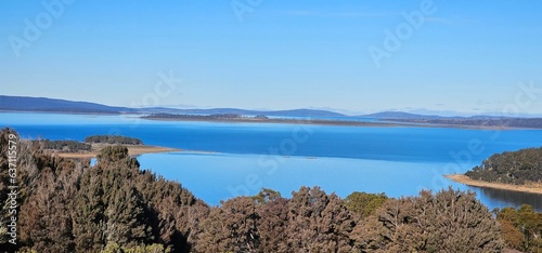 Scenic view of a tranquil Trout lake surrounded by lush mountains in the background photo