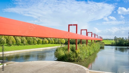 Pont Rouge in Cergy, France against a cloudy blue sky photo