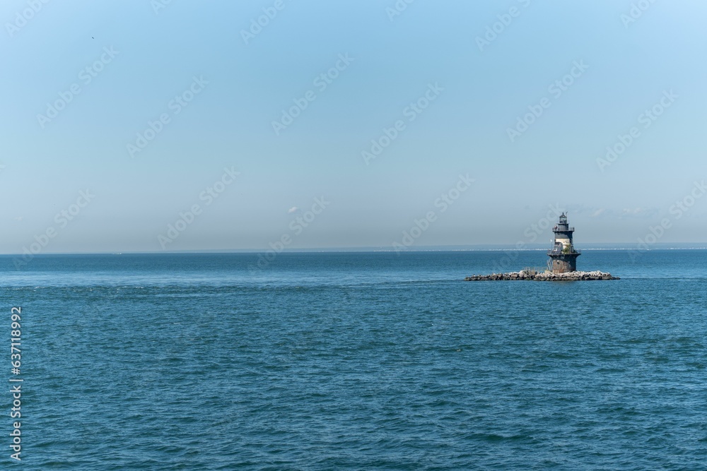 Orient Point Lighthouse in the blue sea on a sunny day in New York State
