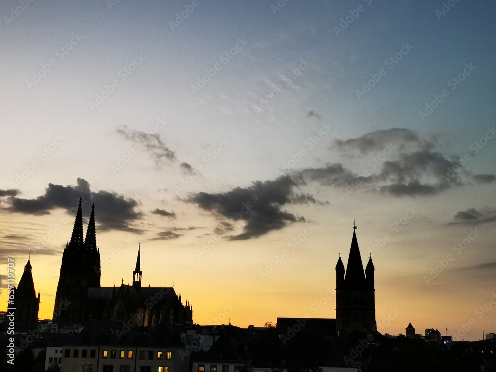 The Cologne Cathedral and the Great St Martins Church as a silhouette at sunset.