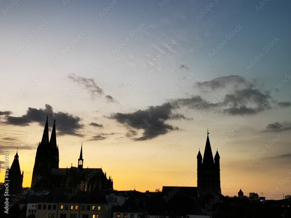 Naklejka premium The Cologne Cathedral and the Great St Martins Church as a silhouette at sunset.