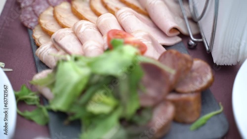 Served table with sausage and cold cuts. Slow motion photo