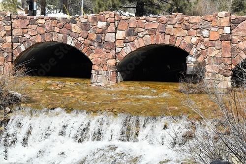 Water Cascades Beneath Old Stone Bridge