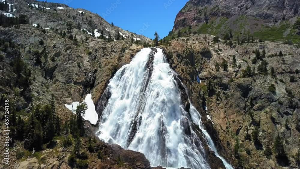 Aerial Panning Shot Of Waterfall At Mountain Range Against Blue Sky On Sunny Day - Mammoth Lakes, California Aerial Panning Shot Of Waterfall At Mountain Range Against Blue Sky On Sunny Day - Mammoth Lakes, California