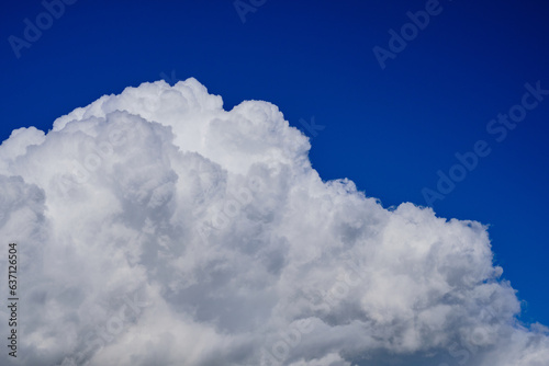 Big fluffy stormy clouds on blue sky