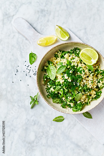 Bulgur-kale tabbouleh with herbs and lime-garlic dressing. Top view. Copy space