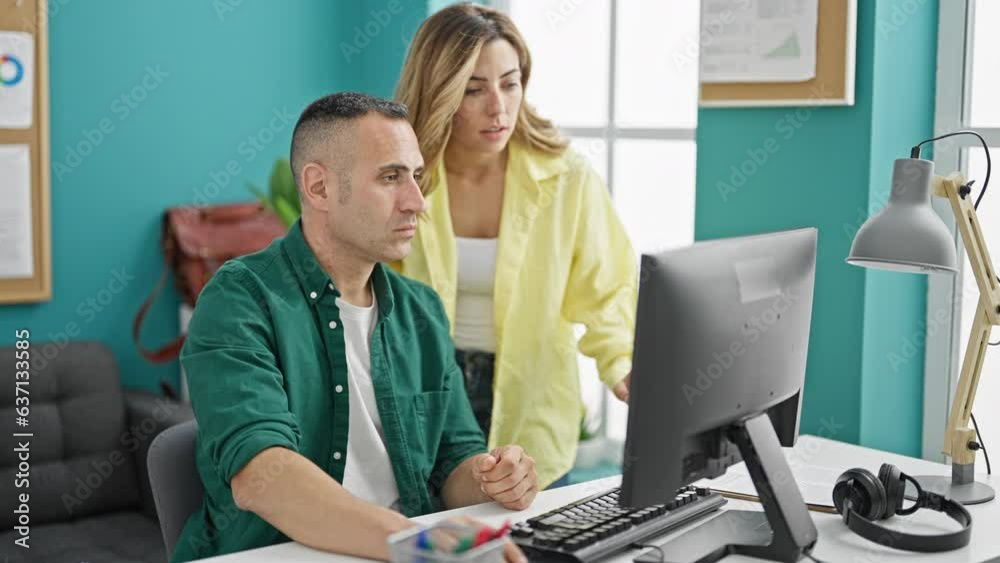 Man and woman business workers using computer working at the office Man and woman business workers using computer working at the office