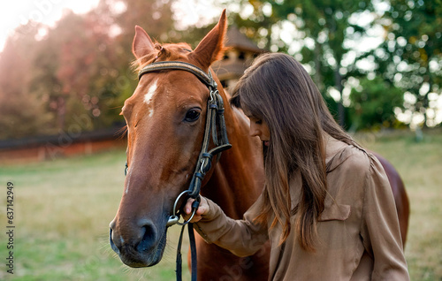 A woman and her horse in rural surroundings, on a grassy field. Portrait of a young equestrian amid nature, training horses, and utilizing a mock outdoor arena. Promote well-being and stress relief.