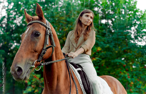Horse riding experience. Horseback journey. Meadow encounter: woman, horse, nature. Equestrian benefits, lessons, emotional renewal. young woman with her horse. Graceful lady riding a horse © Sundaylights