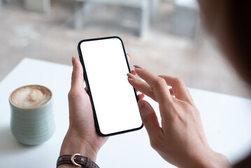 Mockup, woman's hand holding using mobile phone at coffee shop with copy space, white blank screen for text, mobile app design and advertising, online marketing