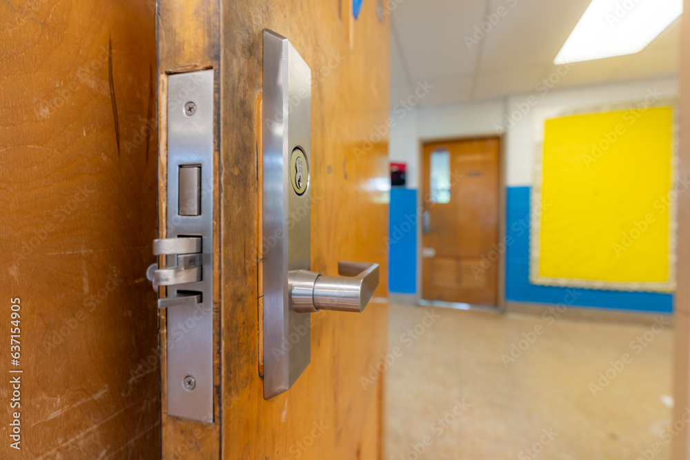 Open classroom door with new door hardware with security locks for a
