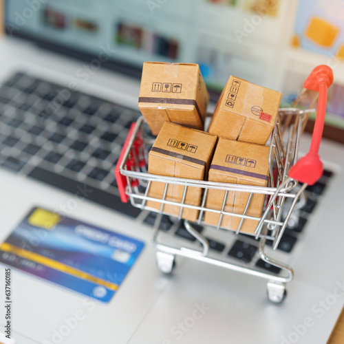 Boxes with credit card on a laptop computer. online shopping, Marketplace platform website, technology, ecommerce, shipping delivery, logistics and online payment concepts