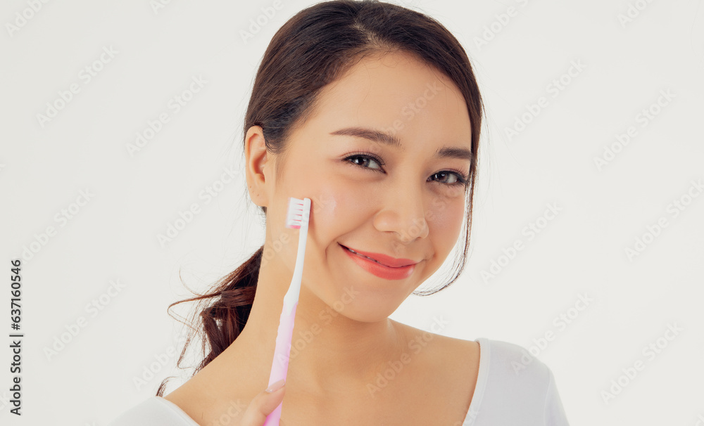 Asian woman beautiful clean teeth : Happy woman taking care of her teeth perfectly shows toothbrush to prevent tooth decay and treat oral cavity : Row of white clean attractive teeth beautiful smile. Asian woman beautiful clean teeth : Happy woman taking care of her teeth perfectly shows toothbrush to prevent tooth decay and treat oral cavity : Row of white clean attractive teeth beautiful smile.