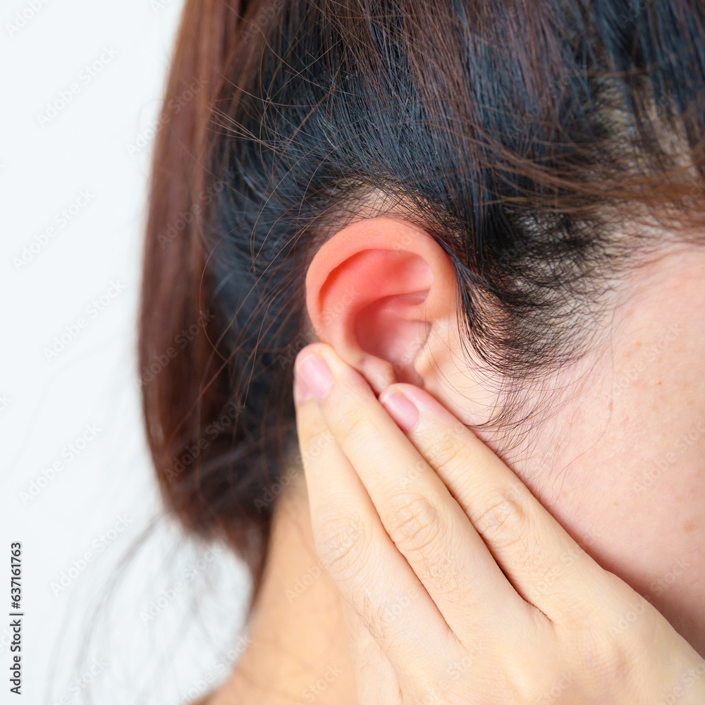 Woman holding her painful Ear. Ear disease, Atresia, Otitis Media, Inflation, Pertorated Eardrum, Meniere syndrome, otolaryngologist, Ageing Hearing Loss and Health concept Woman holding her painful Ear. Ear disease, Atresia, Otitis Media, Inflation, Pertorated Eardrum, Meniere syndrome, otolaryngologist, Ageing Hearing Loss and Health concept