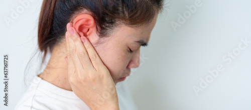 Woman holding her painful Ear. Ear disease, Atresia, Otitis Media, Inflation, Pertorated Eardrum, Meniere syndrome, otolaryngologist, Ageing Hearing Loss and Health concept photo
