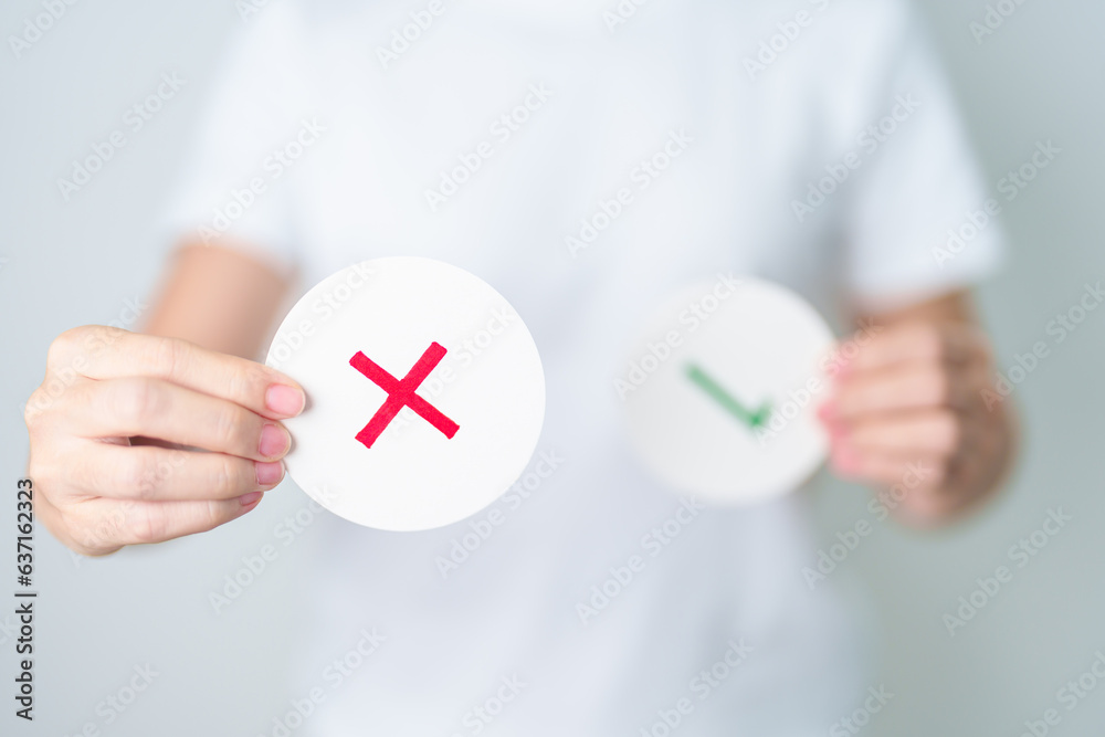 Woman show Wrong symbol paper. True and false, accept and rejected, evaluation, Vote, Poll, Yes or No and Survey concepts Woman show Wrong symbol paper. True and false, accept and rejected, evaluation, Vote, Poll, Yes or No and Survey concepts