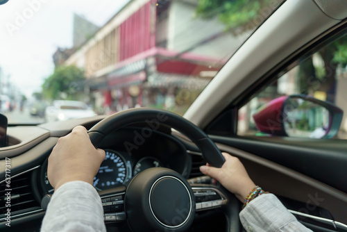 Woman driving car. girl feeling happy to drive holding steering wheel and looking on road