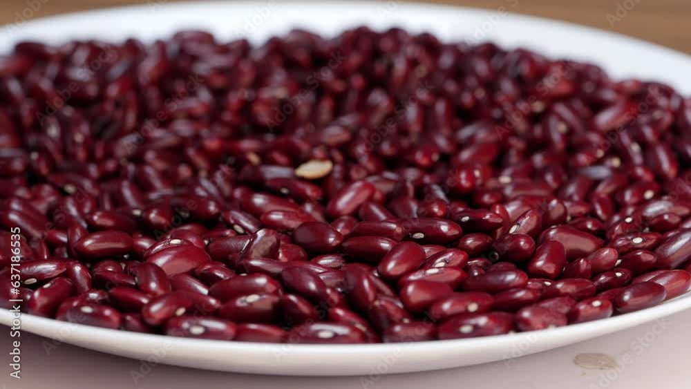 Red beans are displayed on a white plate Red beans are displayed on a white plate