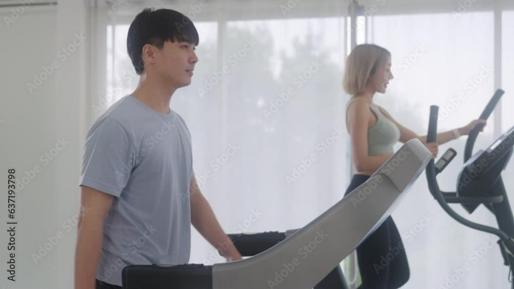 A group of multiethnic young people running on a treadmill in the gym. Cardio workout. The concept of sports and recreation. A group of multiethnic young people running on a treadmill in the gym. Cardio workout. The concept of sports and recreation.