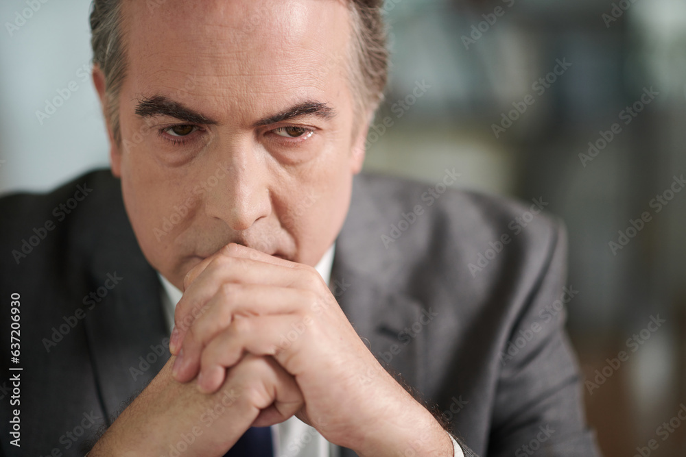 Serious attorney thinking about difficult case of his client Serious attorney thinking about difficult case of his client