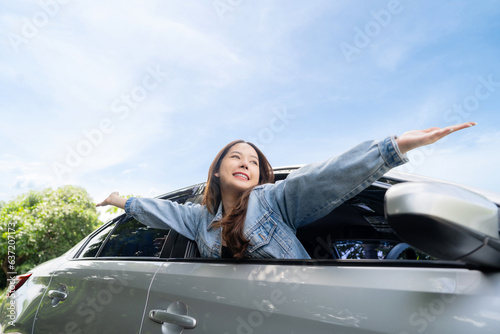 Young beautiful asian women getting new car. She relaxing out of window in a car - Freedom car travel concept