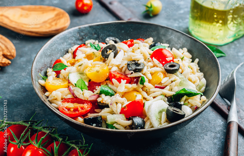 Mediterranean orzo salad with black olive, basil, red onion, tomato and cucumber.