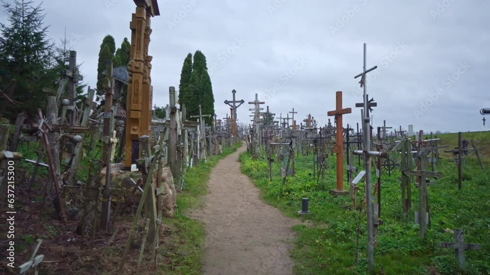 Handheld POV shot following a narrow path with thousands of catholic crosses Handheld POV shot following a narrow path with thousands of catholic crosses