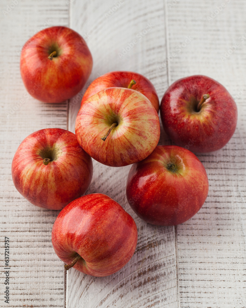 Ripe juicy red apples on a wooden white background. Harvesting. Ripe juicy red apples on a wooden white background. Harvesting.
