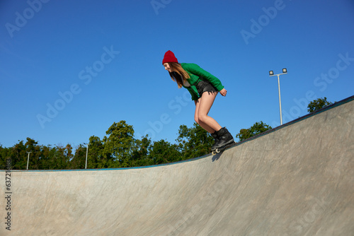 Teenager girl wearing roller blades enjoying extreme sports event