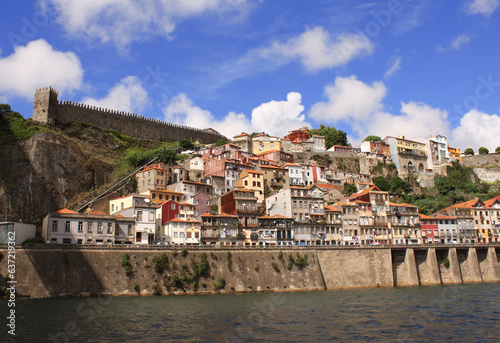 Embankment in Old Porto district, Porto, Portugal. Front view of historical center with colorful medieval houses of Oporto city, Ribeira. View from Douro river