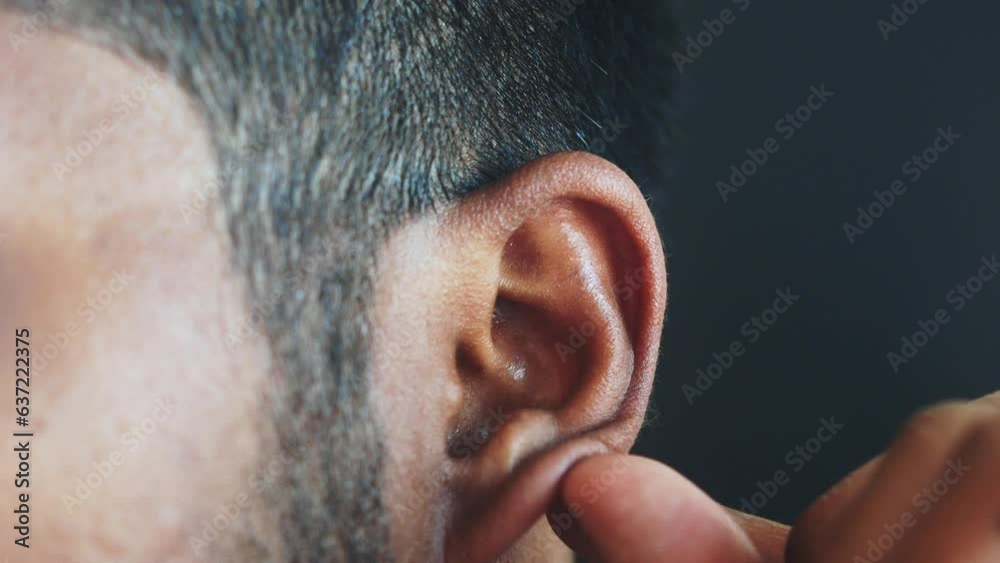 young man having ear pain touching his painful ear , young man having ear pain touching his painful ear ,