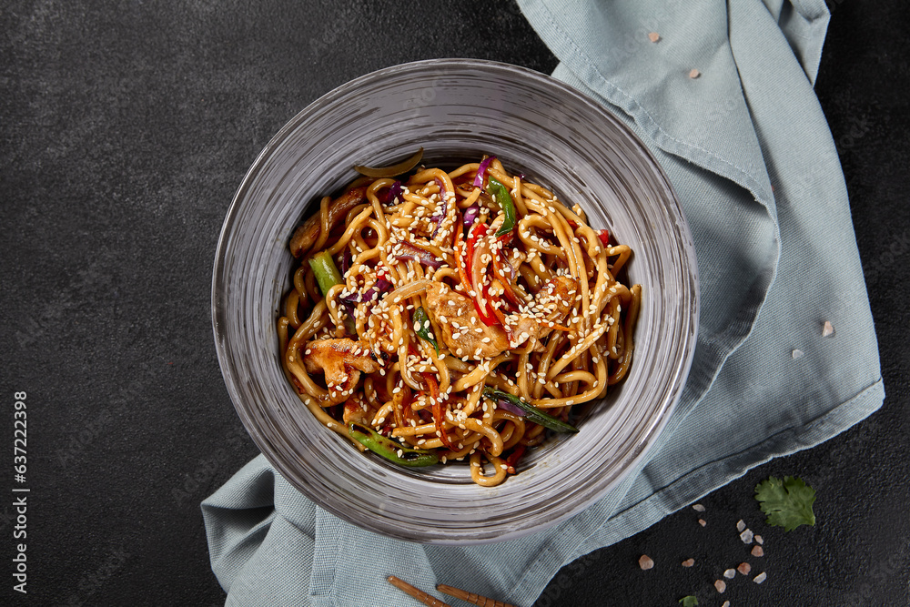 Udon noodles perfectly tossed with chicken and assorted vegetables in a ...