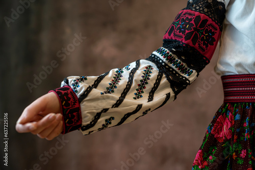 pretty lady in ukrainian national clothes with a headscarf isolated on dark background