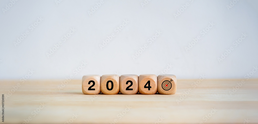 2024 Happy New year background. 2024 year number and target icon on wooden cube blocks arranged on white banner background with copy space. Welcome, Merry Christmas. Business goal and success concept.