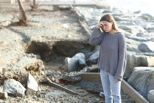 Sad girl looking at disaster after storm