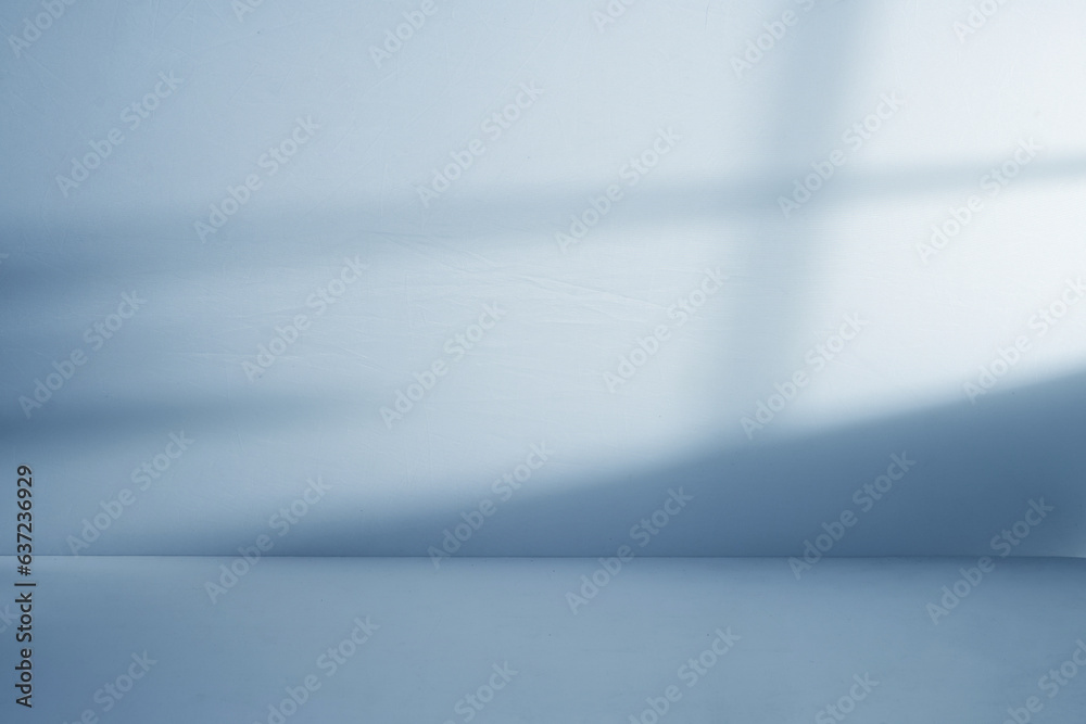 Blue studio space with window shadow Blue studio space with window shadow