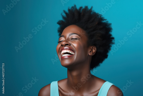 Portrait of a Happy Woman Laughing Black Woman Blue Background © Lais