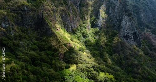 Sunlight Moving Across Lush Green Mountain and Tropical Rainforest as the Clouds Change Overhead on Fatu Hiva Island Marquesas South Pacific French Polynesia photo