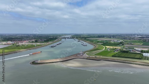 Awesome Aerial View of Cargo Ship Sailing at Hansweert Lock Entrance, Netherlands photo