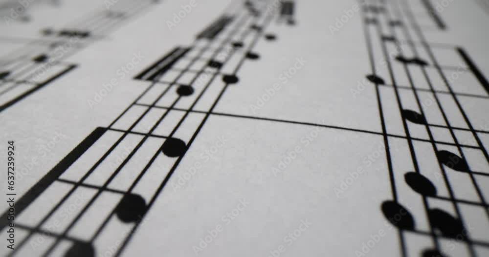 Notebook with musical notes for performing symphony at concert. Paper sheet with musical notes of classical composition for instrument