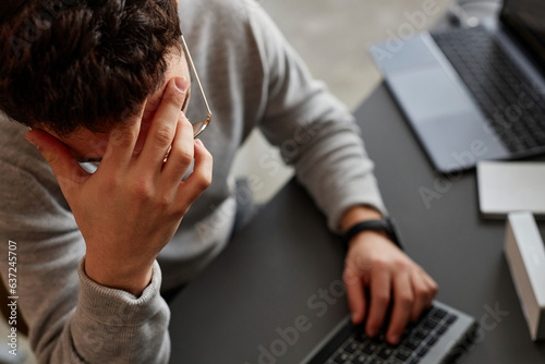 Stressed IT professional sitting at desk