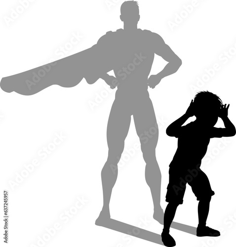 A superhero child or kid boy revealed by his shadow silhouette as a super hero in a cape.
